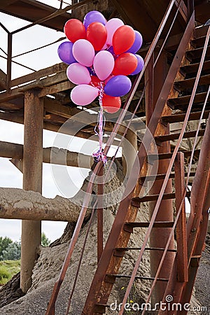 Color balloons on rusty staircase Stock Photo