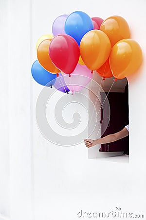 Color balloons from window Stock Photo