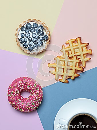 Color block flat lay with coffee, donut, tart and waffles Stock Photo