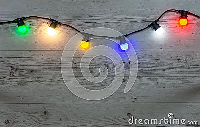 Color lamps garland on the wooden background Stock Photo