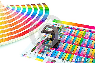 Color management in printing process with magnifying glass and paint guide. Stock Photo