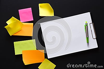 Color notes and note paper on black board, copy space Stock Photo