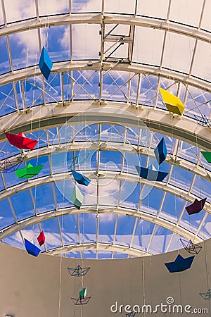 Color paper boats hanging from the ceiling Editorial Stock Photo