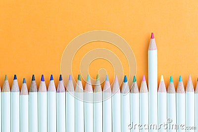 Color pencil in row with stand out pink one using as individual creativity, leadership or feminine and woman leader idea Stock Photo