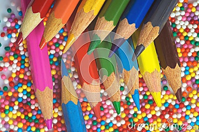 Color pencils on the background of texture multi-colored balls close-up. Set for children`s creativity and development Stock Photo