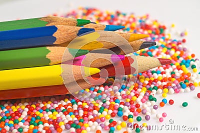 Color pencils on the background of texture multi-colored balls close-up. Set for children`s creativity and development Stock Photo