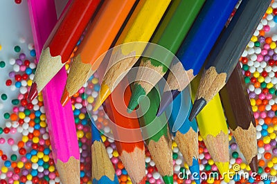 Color pencils on the background of texture multi-colored balls close-up. Set for children`s creativity and development Stock Photo