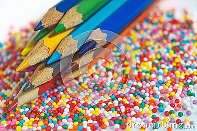 Color pencils on the background of texture multi-colored balls close-up. Set for children`s creativity and development Stock Photo