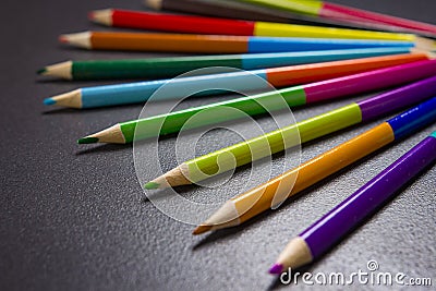 Color pencils on black background closeup. Creative concept. Stock Photo