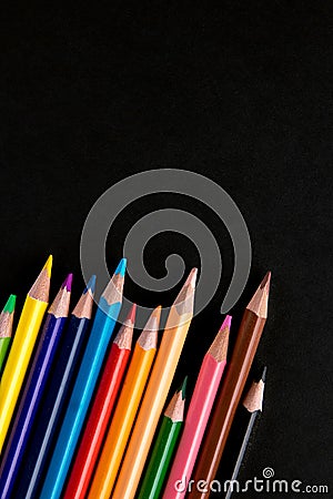 Color pencils on black background flat lay. Place for text Stock Photo