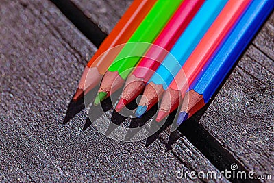 Color pencils close-up on a wooden table. Pencils to school. Bright design solutions Stock Photo