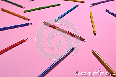 Color pencils on pink pastel background, close up. Set of colorful pencils, copy space. Crayons. Top view, flat lay. Stock Photo