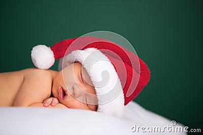 Christmas Newborn Baby Wearing Santa Hat and Sleeping Stock Photo