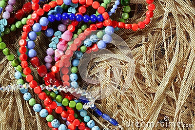 Color stones jewelry necklaces, straw background Stock Photo