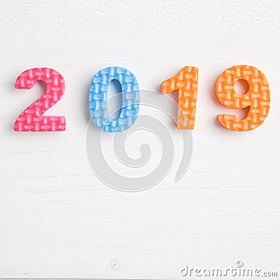 Color toy foam numbers in 2019 on bright wooden surface Stock Photo