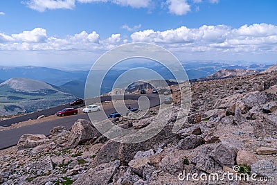 Cars parked along the side of the road along Mount Evans, a 14er mountain in the Arapaho and Editorial Stock Photo