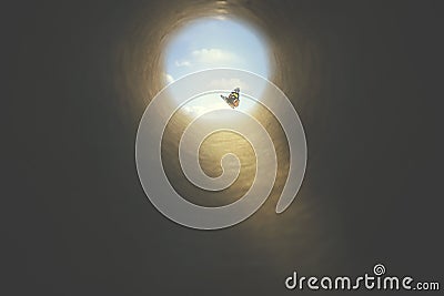 Colorated butterfly finds its way out of a dark tunnel, concept of freedom Stock Photo