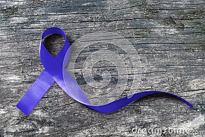 Colorectal/ Colon cancer, Cri du Chat and Acute Respiratory Distress Syndrome ARDS awareness with dark blue ribbon on old wood Stock Photo