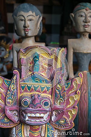 Colored Balinese wooden statues in tourist market in Ubud. Indonesia Stock Photo