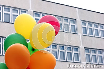 Colored balloons on the background of the school building. Back to school concept Stock Photo