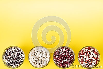 Colored bean in glass jars on a yellow background. Image with copy space Stock Photo
