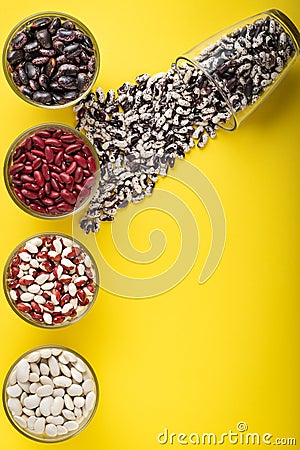 Colored bean in glass jars on a yellow background. Image with copy space Stock Photo