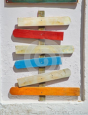 Colored blank wooden signboards pointing to different directions. Stock Photo