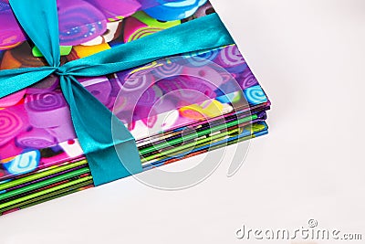 Colored books in a stack. Children`s books in a gift ribbon. Bright colorful little books for children. Stock Photo