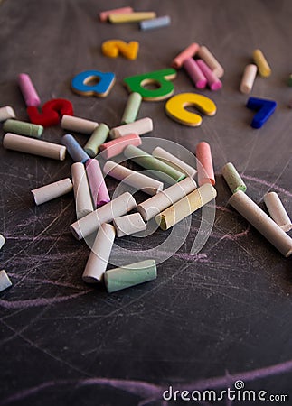 Colored chalks numbers and letters on blackboard Stock Photo