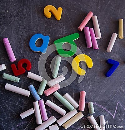 Colored chalks numbers and letters on blackboard Stock Photo