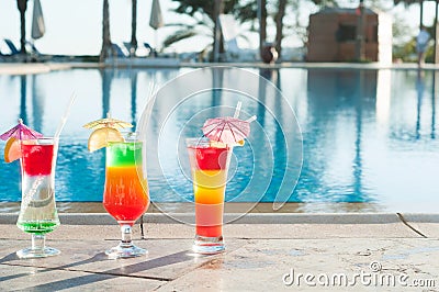 Colored cocktails on a background of water. Stock Photo