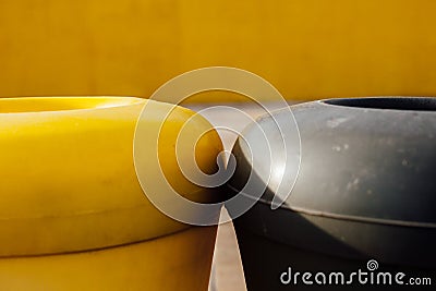 Colored containers in the city, black and yellow Stock Photo