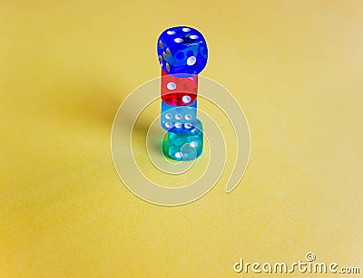 colored dices showing different numbers on yellow background. Free copy space. Concept of game, winning combination. Colored Stock Photo