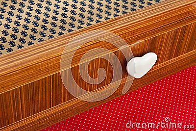 Colored drawer wooden furniture with heart shaped knob. Stock Photo