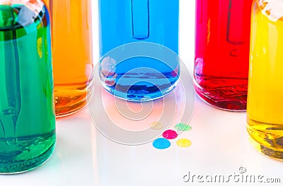 Colored drops and transparent glass bottles filled colored liquid with dropper Stock Photo