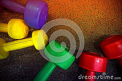 Colored dumbbells on a black background Stock Photo