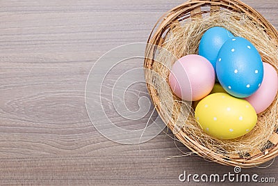 Easter eggs in the basket on wooden background Stock Photo