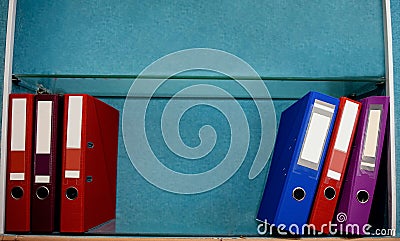 Colored Folders For Office Files And Paper On A Shelf. Stock Photo