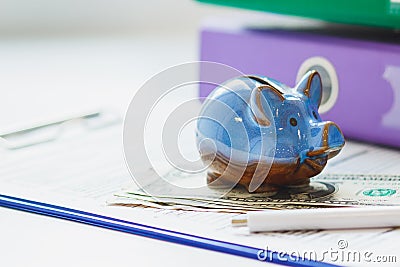 Colored folders, piggy bank, clean insurance form, money and a pen Stock Photo