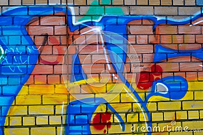 Colored graffiti on a brick wall Stock Photo
