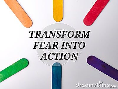 Colored ice cream stick with text TRANSFORM FEAR INTO ACTION Stock Photo