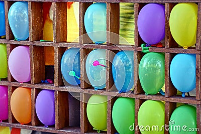 Darts of colored inflatable balls on the shelf Stock Photo