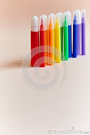 Colored markers thin thick red yellow green pink blue purple light background. Stock Photo