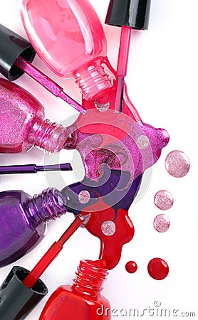 Colored nail polish spilling from bottles Stock Photo