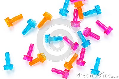 Colored neon translucent plastic toy bolts on white background. Flat lay. Concept World Dad`s Day, unisex toys. Stock Photo