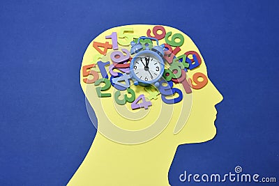 Colored numbers and alarm clock on male head contour Stock Photo