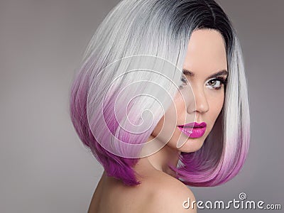 Colored Ombre hair extensions. Beauty Model Girl blonde with short bob purple hairstyle isolated on gray background. Closeup Stock Photo