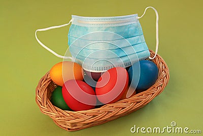 Colored eggs in basket medical mask Easter 2020 Stock Photo