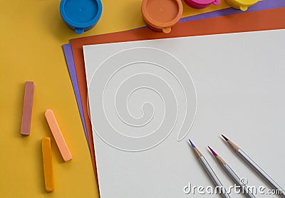 Colored paper and paints on the table Stock Photo