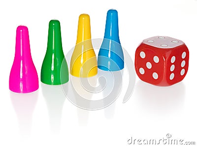 Colored pawns and red dice. Set pieces in the colors yellow, green, blue. Cube in red with white eyes. Stock Photo